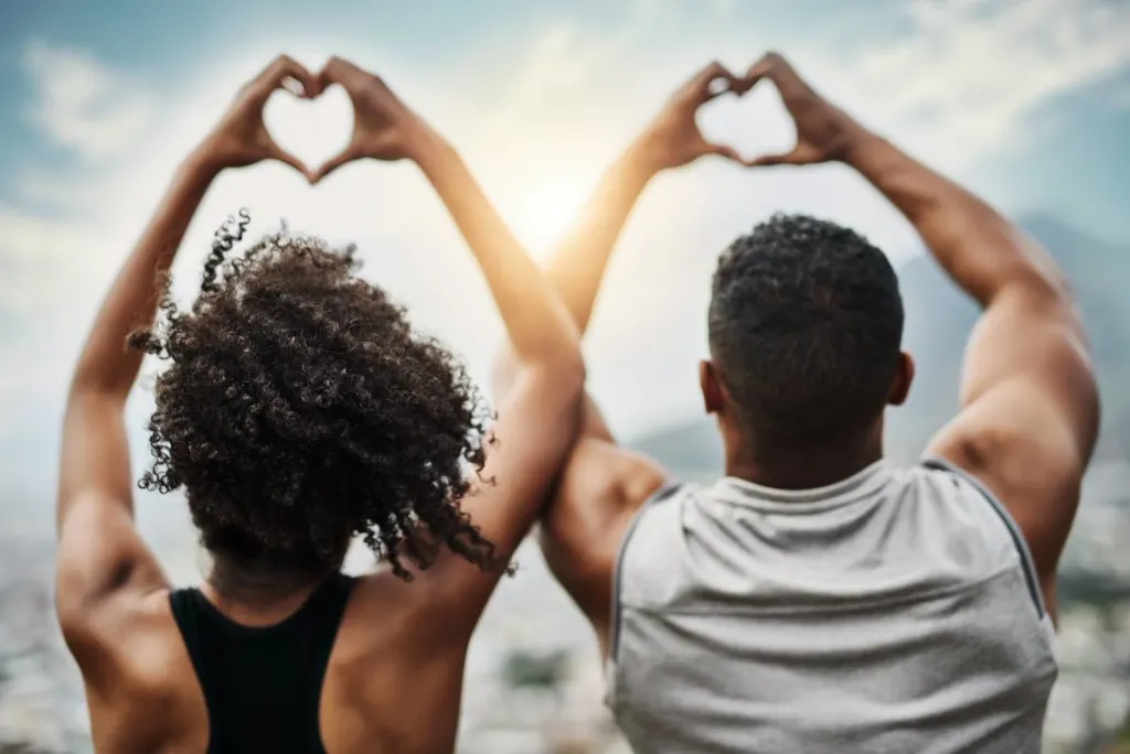 Couple making heart shapes with their hands